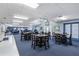 Spacious common room with tables, chairs, and carpeted floors, perfect for gatherings at 122 Baytree Blvd, Tavares, FL 32778