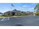 Community clubhouse featuring a well-maintained exterior, ample parking, and landscaped surroundings, offering a welcoming atmosphere at 122 Baytree Blvd, Tavares, FL 32778