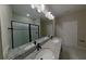 Elegant bathroom boasting double vanity and granite countertop at 715 Griffon Ave, Lake Alfred, FL 33850