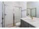 Modern bathroom with gray vanity, white tile shower, and updated fixtures at 10125 Gobat Aly, Orlando, FL 32827