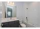 Clean bathroom with gray vanity, bathtub, and white tile at 10125 Gobat Aly, Orlando, FL 32827