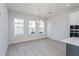 Bright dining room with wood-look floors and a modern chandelier at 10125 Gobat Aly, Orlando, FL 32827