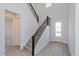 Two-story entryway with a modern staircase and light-colored wood floors at 10125 Gobat Aly, Orlando, FL 32827