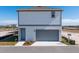 Two-story house with gray garage door and light-colored siding at 10125 Gobat Aly, Orlando, FL 32827