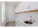 Laundry room with white cabinets and a utility sink at 10125 Gobat Aly, Orlando, FL 32827