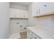 Laundry room with white cabinets and countertop at 10125 Gobat Aly, Orlando, FL 32827