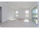 Living area with wood-look floors, lots of natural light, and sliding glass doors at 10125 Gobat Aly, Orlando, FL 32827