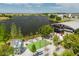 A vibrant community area with tables, a lake, and an artful glass cube structure at 10218 Dulbecco St, Orlando, FL 32827