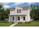Charming two-story home with light blue siding, inviting front porch, and beautifully landscaped front yard at 10218 Dulbecco St, Orlando, FL 32827