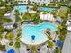 Aerial view of community pools with lounge seating, umbrellas, and lush landscaping at 10218 Dulbecco St, Orlando, FL 32827