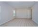 Bright bedroom with neutral carpeting and large window at 10260 Medawar St, Orlando, FL 32827