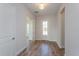 Bright entryway with wood-look tile floor and neutral colors at 10260 Medawar St, Orlando, FL 32827