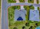 This stunning aerial view highlights the property's solar panels and verdant lawn at 1751 Ashwood Run, The Villages, FL 32162
