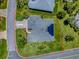 A beautiful aerial view of home showcasing its well-manicured lawn, complemented by solar panels on the roof at 1751 Ashwood Run, The Villages, FL 32162