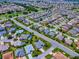 A breathtaking aerial view of this home situated in a well-manicured neighborhood surrounded by trees and other homes at 1751 Ashwood Run, The Villages, FL 32162