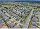 Aerial view of a lovely home in a well-maintained neighborhood featuring mature trees and landscaping at 1751 Ashwood Run, The Villages, FL 32162