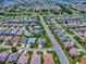 A captivating aerial view shows this home nestled in a well-manicured neighborhood at 1751 Ashwood Run, The Villages, FL 32162