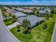 Charming single-story home featuring lush green lawn, mature landscaping, and a circular driveway at 1751 Ashwood Run, The Villages, FL 32162