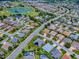 A serene aerial view of the property situated in a picturesque neighborhood, complete with lush landscaping at 1751 Ashwood Run, The Villages, FL 32162