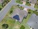 Aerial view of property showcasing a landscaped yard, solar panels, and neighborhood setting at 1751 Ashwood Run, The Villages, FL 32162