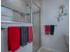 Bathroom with shower behind glass door and decorative wall decor, with colorful towels at 1751 Ashwood Run, The Villages, FL 32162