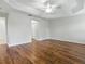 Open bedroom featuring wood floors, a ceiling fan, and neutral walls, ready for personalization at 1751 Ashwood Run, The Villages, FL 32162