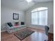 Comfortable bedroom/den features natural light, hardwood floors, and comfortable sofa for relaxing at 1751 Ashwood Run, The Villages, FL 32162