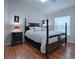 Elegant bedroom features a four-poster bed, hardwood floors, and a serene atmosphere at 1751 Ashwood Run, The Villages, FL 32162
