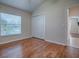 Bright bedroom with wood floors, ample closet space, and natural light at 1751 Ashwood Run, The Villages, FL 32162