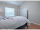 Bright bedroom with hardwood floors features a four-poster bed and ample natural light at 1751 Ashwood Run, The Villages, FL 32162