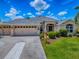 Lovely single-story home featuring a three-car garage, landscaped yard, and inviting front entrance at 1751 Ashwood Run, The Villages, FL 32162