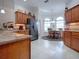 Spacious eat-in kitchen featuring granite countertops, stainless steel refrigerator, and beautiful wooden cabinets at 1751 Ashwood Run, The Villages, FL 32162