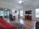 Relaxing living room showcases hardwood floors, comfortable seating, and access to the outdoor patio at 1751 Ashwood Run, The Villages, FL 32162