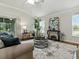 Bright living room features vaulted ceilings, stylish furniture, and sliding glass doors to the lanai at 1751 Ashwood Run, The Villages, FL 32162