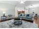 Spacious living room with open layout, features modern decor and seamless flow to kitchen and dining at 1751 Ashwood Run, The Villages, FL 32162