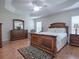 Traditional main bedroom with a large bed, dresser, and windows offering a cozy retreat at 1751 Ashwood Run, The Villages, FL 32162