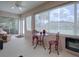 Bright sunroom with garden views, table with chairs, fan and natural light for a relaxing atmosphere at 1751 Ashwood Run, The Villages, FL 32162