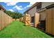 Landscaped backyard with grassy area and wooden fence at 6299 River Run Pl # 198, Orlando, FL 32807