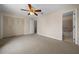 Bright bedroom with ceiling fan and access to bathroom at 6299 River Run Pl # 198, Orlando, FL 32807