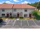 Three-unit building with red tile roofs and parking at 6299 River Run Pl # 198, Orlando, FL 32807