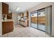 Bright kitchen features wood cabinets, white appliances, and sliding glass door to patio at 6299 River Run Pl # 198, Orlando, FL 32807