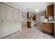 Kitchen with white appliances and wood cabinets at 6299 River Run Pl # 198, Orlando, FL 32807