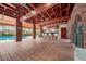 Community pool area with covered patio, seating, and brick building at 6299 River Run Pl # 198, Orlando, FL 32807