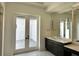 Bathroom with double vanity and private access to patio at 16122 Pendio Dr, Bella Collina, FL 34756