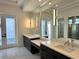 Modern bathroom with double vanity and large mirror at 16122 Pendio Dr, Bella Collina, FL 34756
