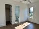 Light-filled bedroom with wood floors and en-suite bathroom at 16122 Pendio Dr, Bella Collina, FL 34756