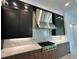 Modern kitchen features dark cabinetry and a gas cooktop at 16122 Pendio Dr, Bella Collina, FL 34756