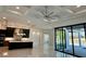 Open living space with kitchen, high ceilings, and pool view at 16122 Pendio Dr, Bella Collina, FL 34756