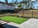 Private putting green with stone patio and fenced yard at 16122 Pendio Dr, Bella Collina, FL 34756