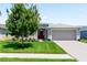 Single-story home with red door, attached garage, and well-manicured lawn at 3682 Arlington Ridge Blvd, Leesburg, FL 34748